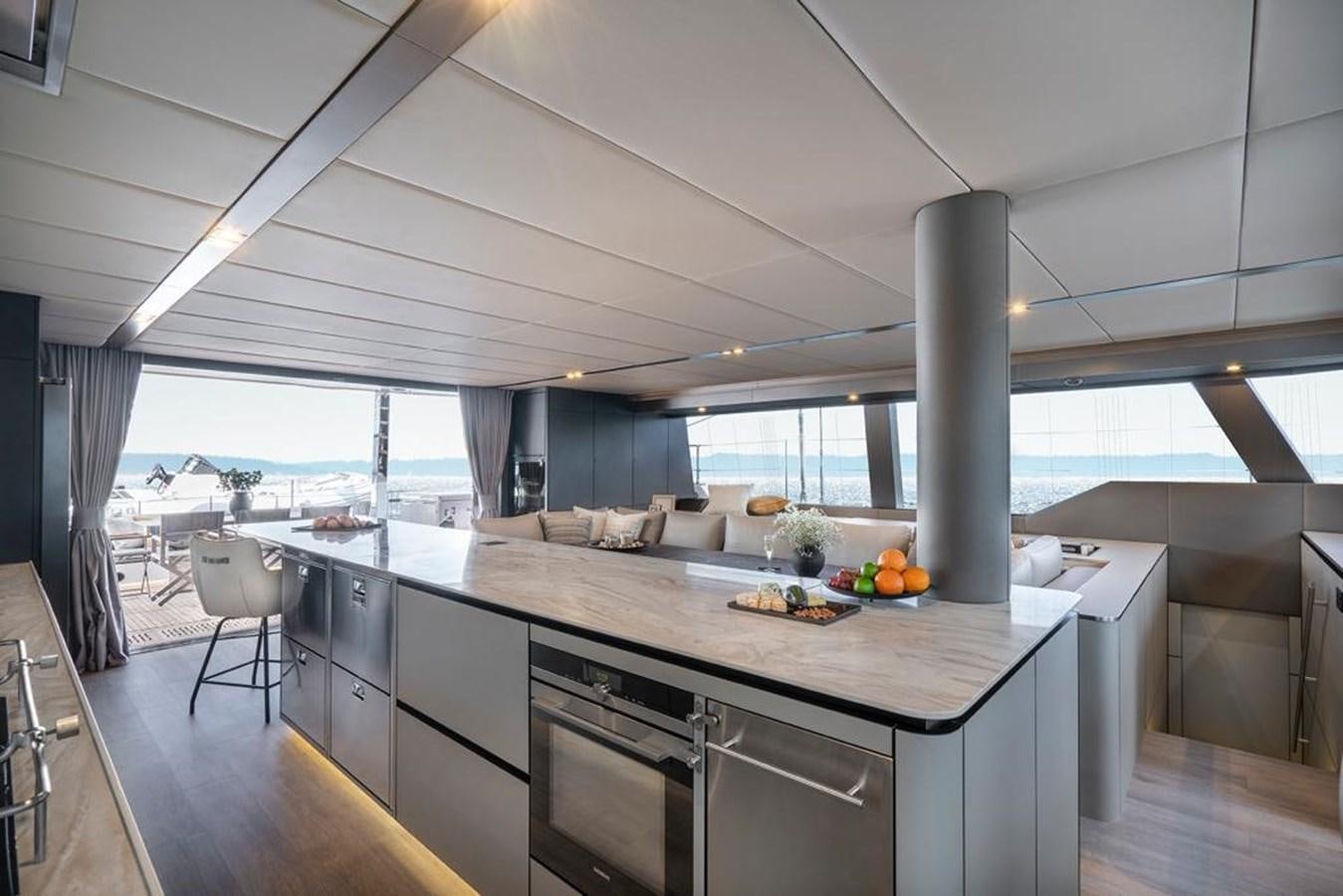 a kitchen with a large island aboard STYLIA Yacht for Sale