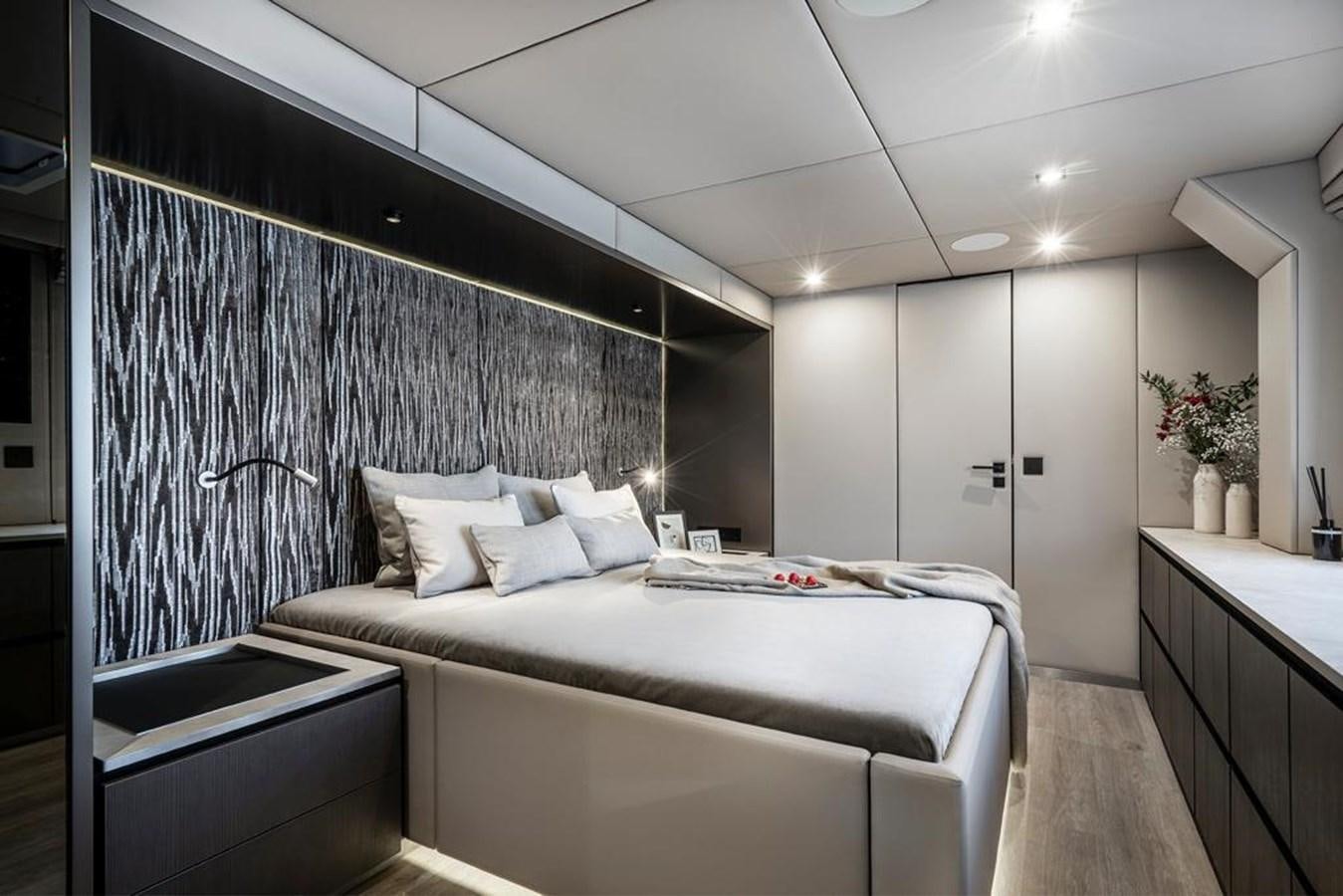 a bedroom with a bed and a desk aboard STYLIA Yacht for Sale