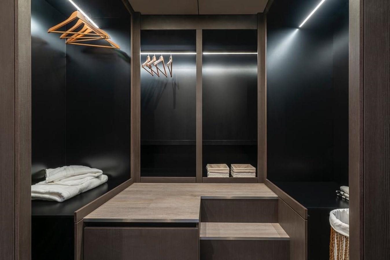 a room with a bed and a bench aboard STYLIA Yacht for Sale