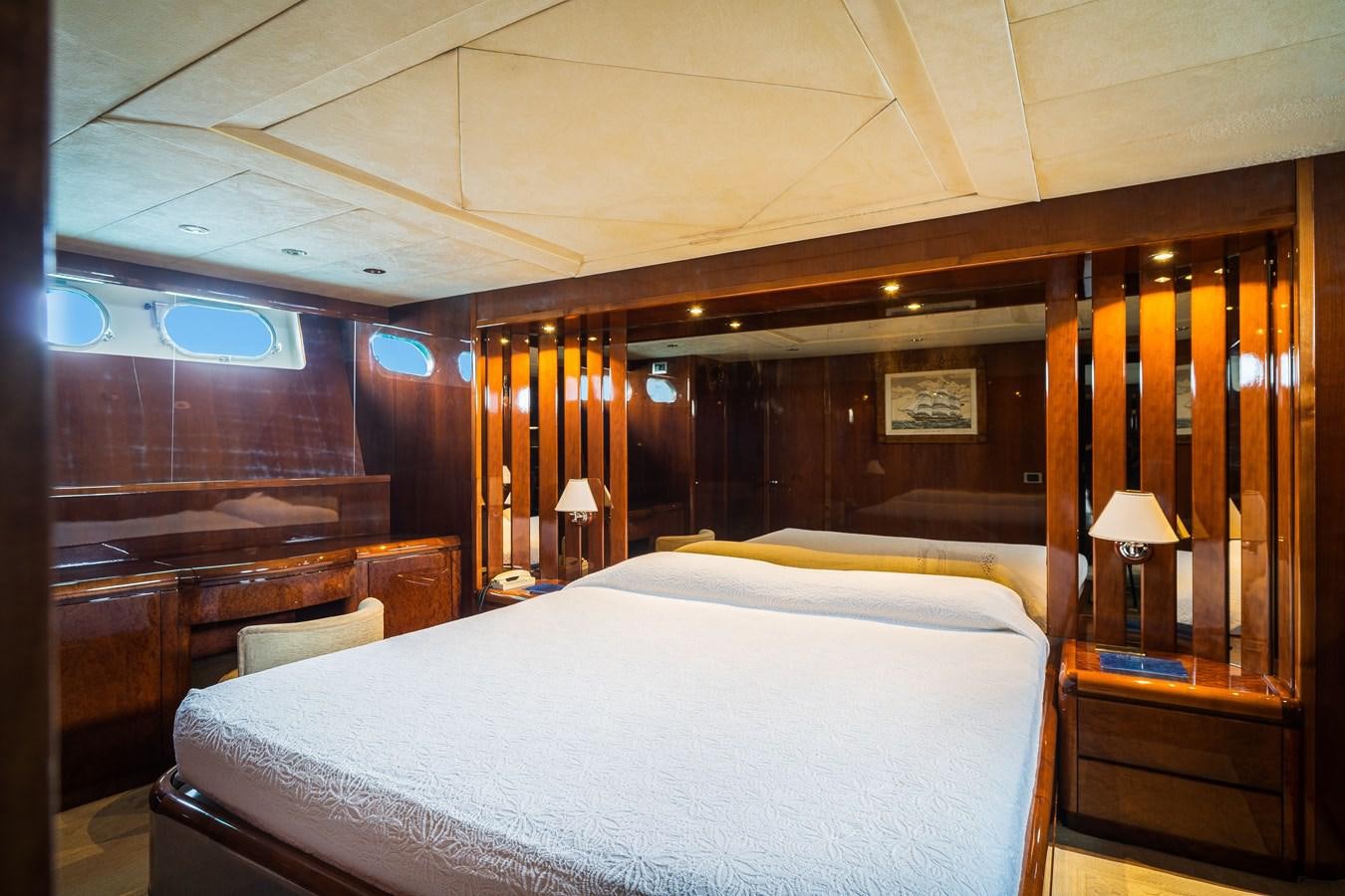 a room with a bed and a desk aboard ALEDOUTHO Yacht for Sale