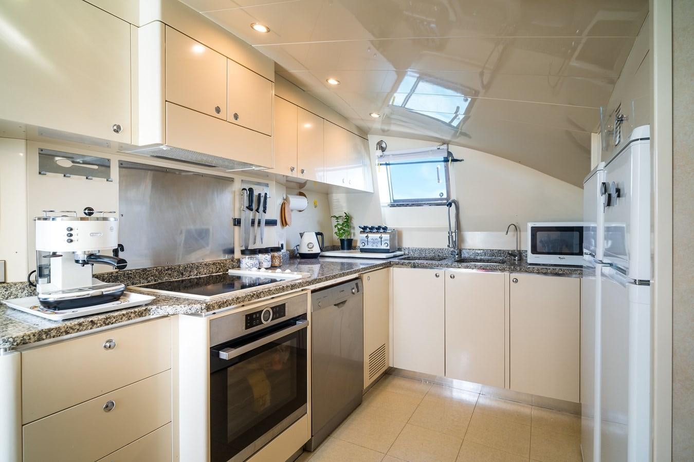 a kitchen with white cabinets aboard ALEDOUTHO Yacht for Sale