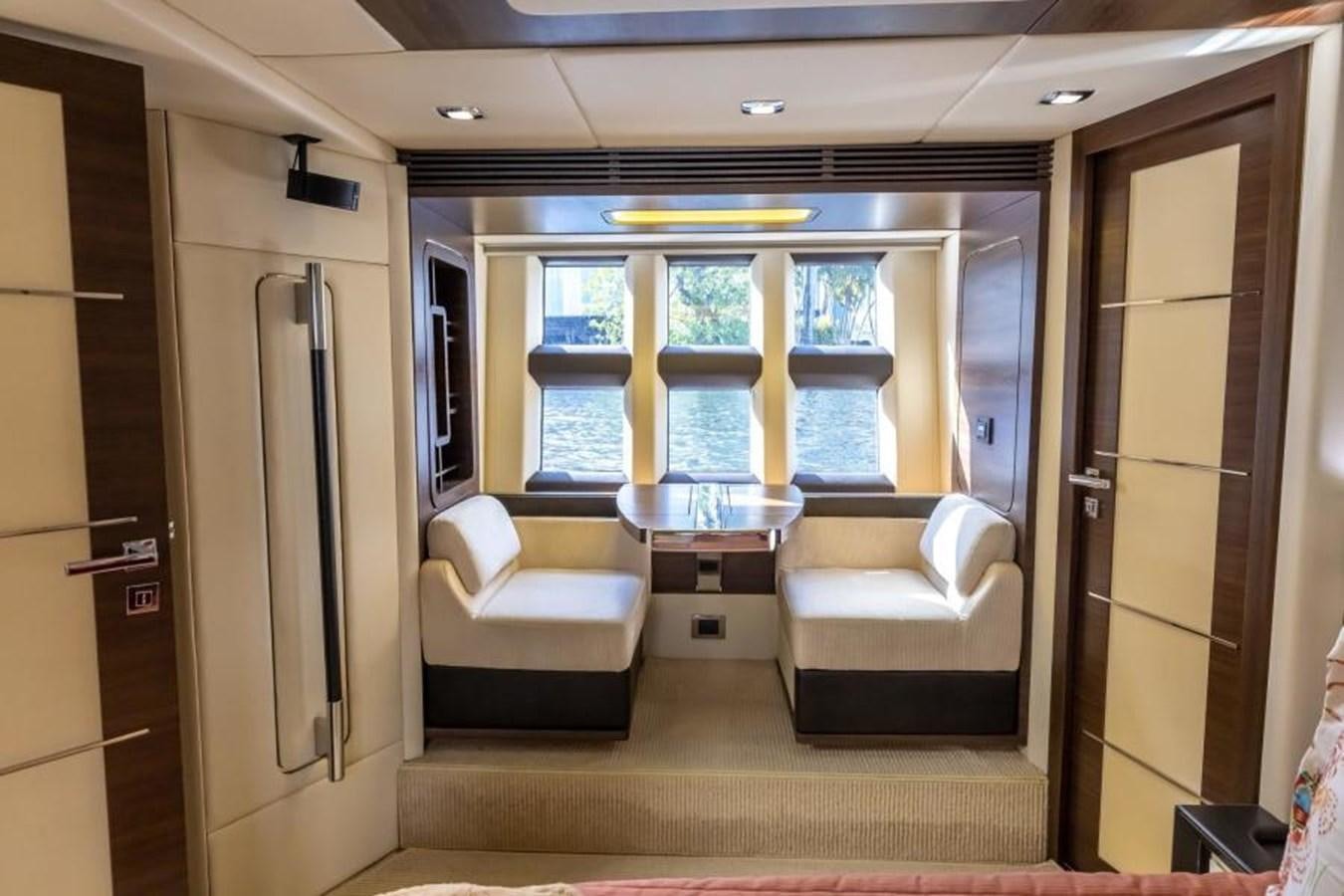 a room with a couch and a table and a window aboard MEANT TO BE Yacht for Sale