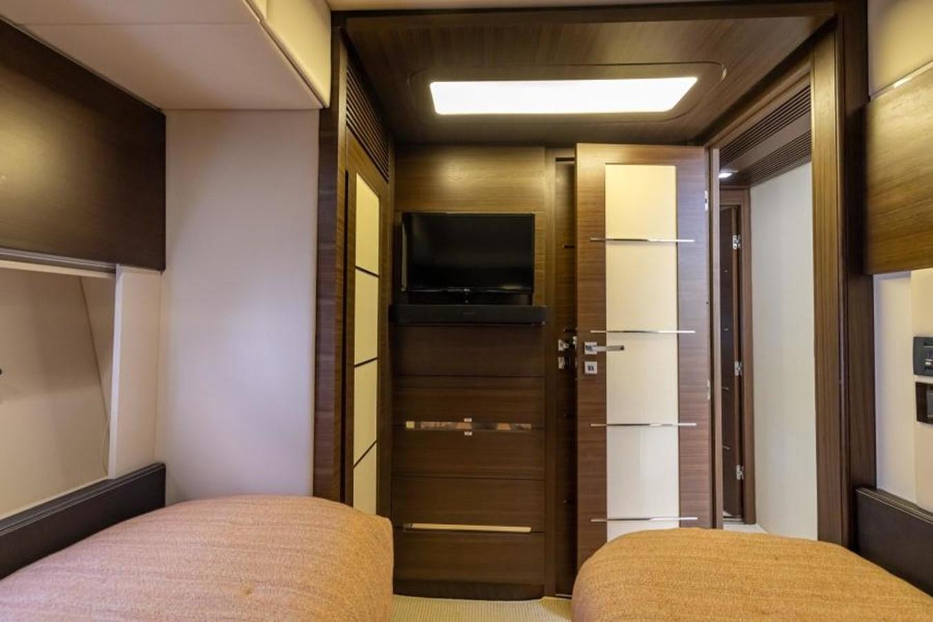 a bedroom with a bed and a television aboard MEANT TO BE Yacht for Sale
