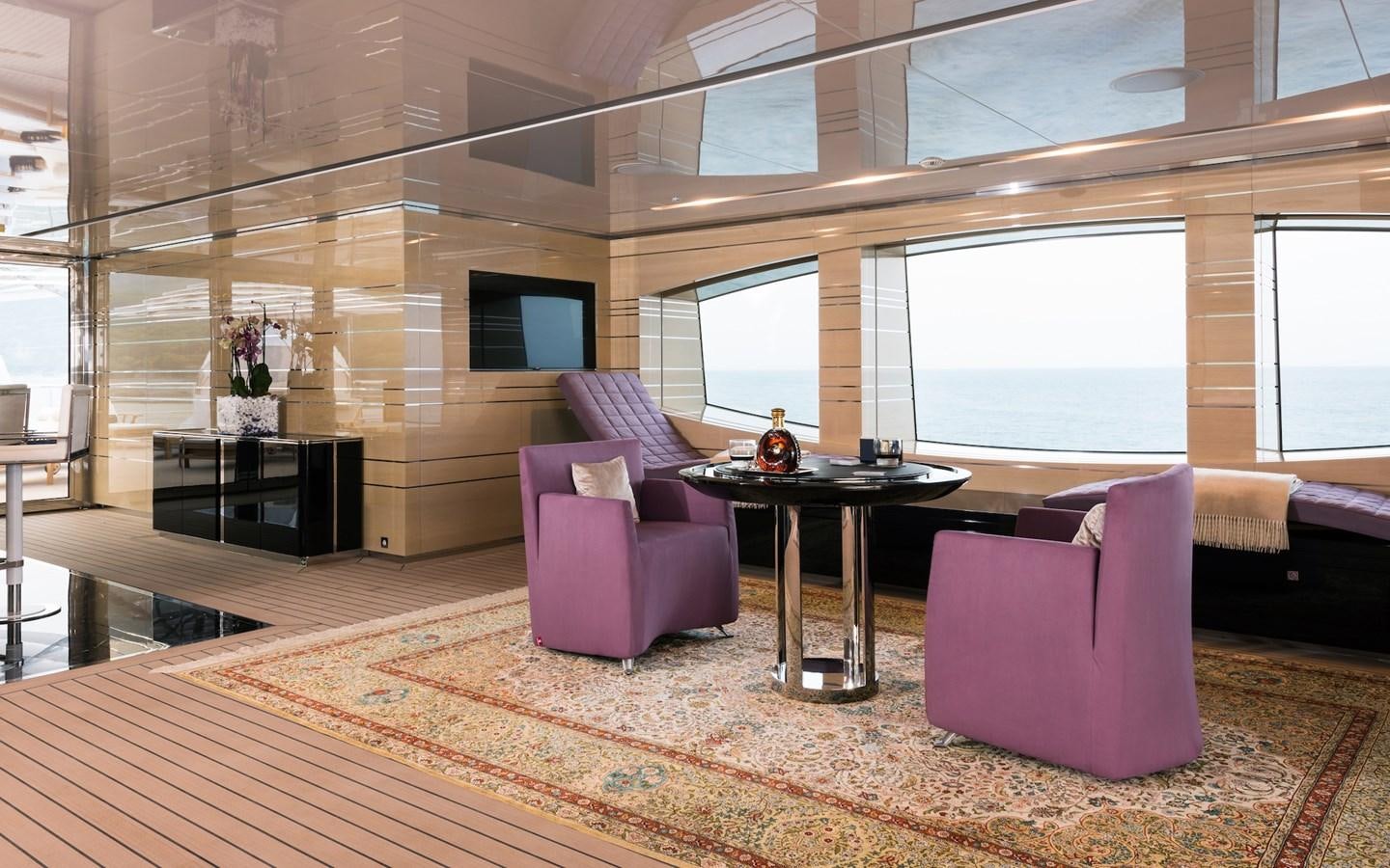 a room with a couch and a table and a tv aboard ALMAX Yacht for Sale