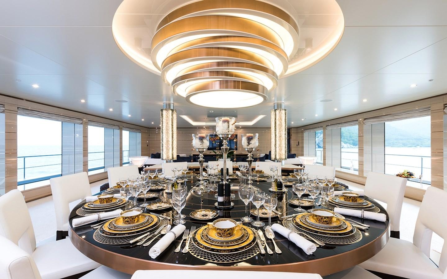 a dining room with a chandelier aboard ALMAX Yacht for Sale