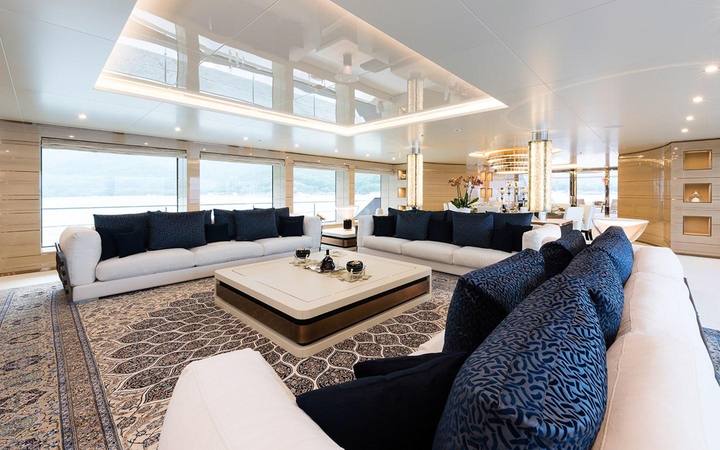 a living room with a large white couch and a white coffee table aboard ALMAX Yacht for Sale