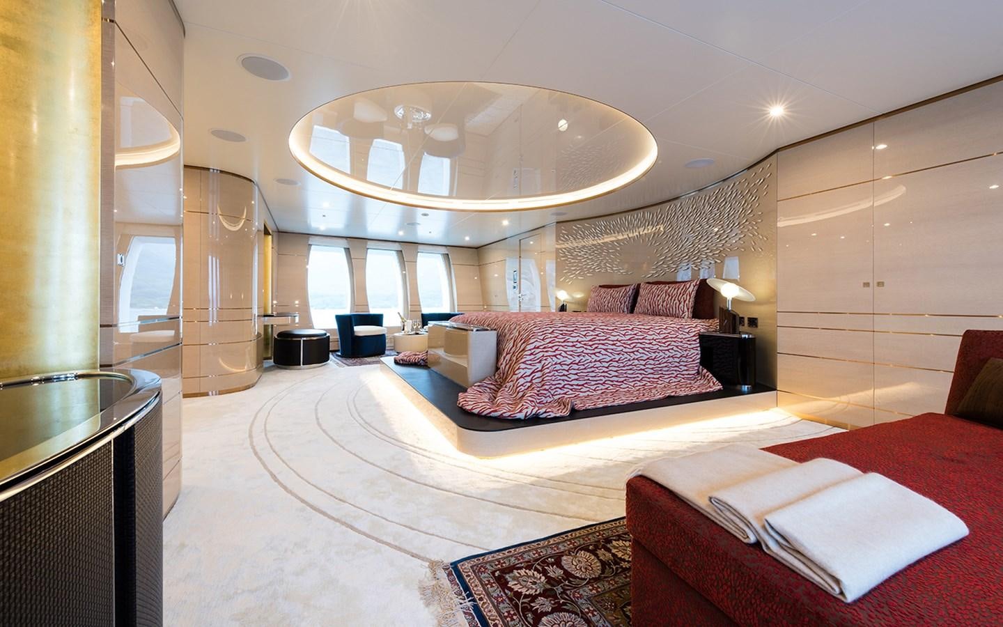 a large bedroom with a chandelier aboard ALMAX Yacht for Sale