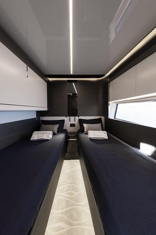 a room with a couple of beds aboard NEVER GIVE UP Yacht for Sale
