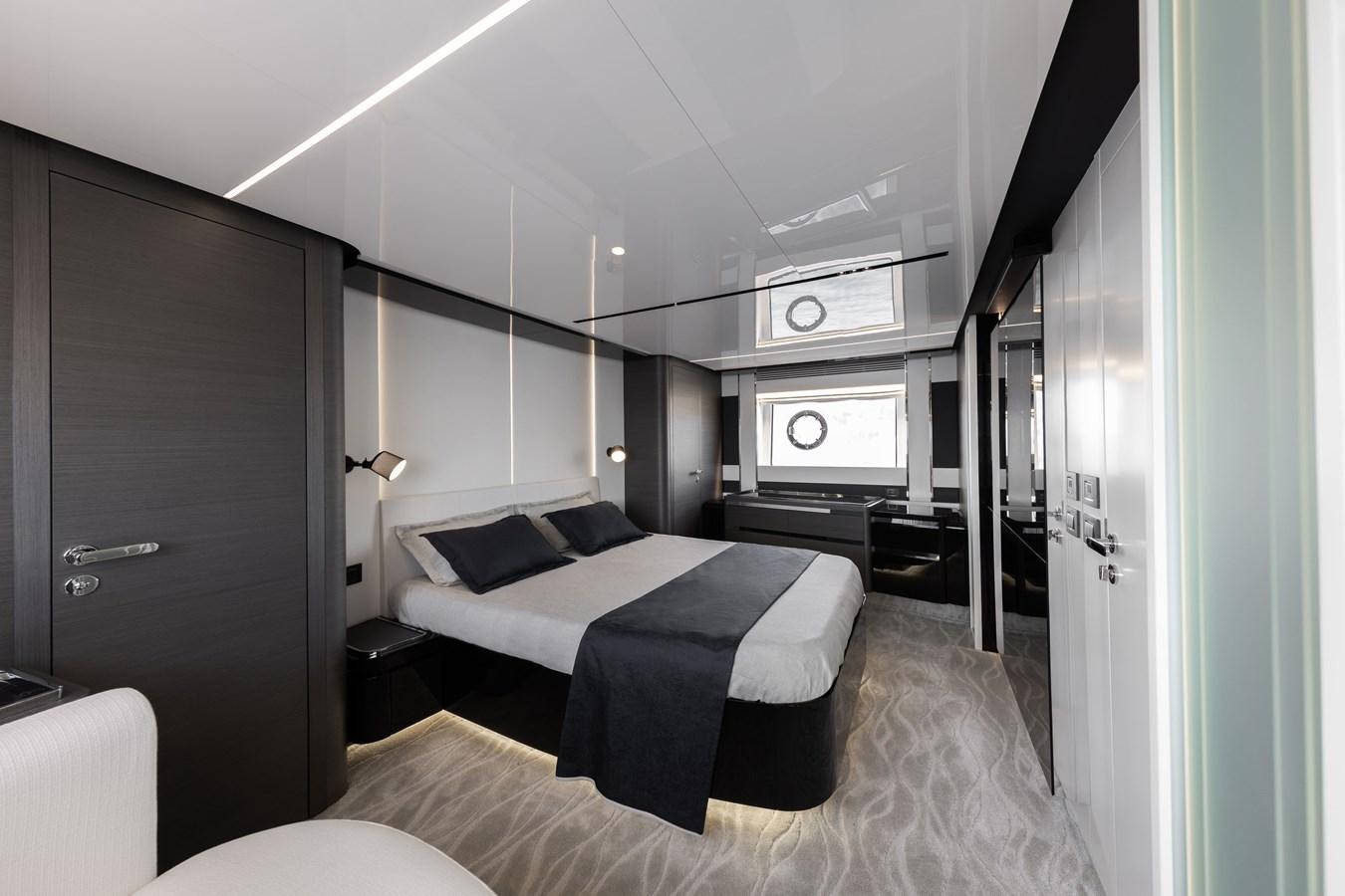 a bedroom with a bed and a tv aboard NEVER GIVE UP Yacht for Sale