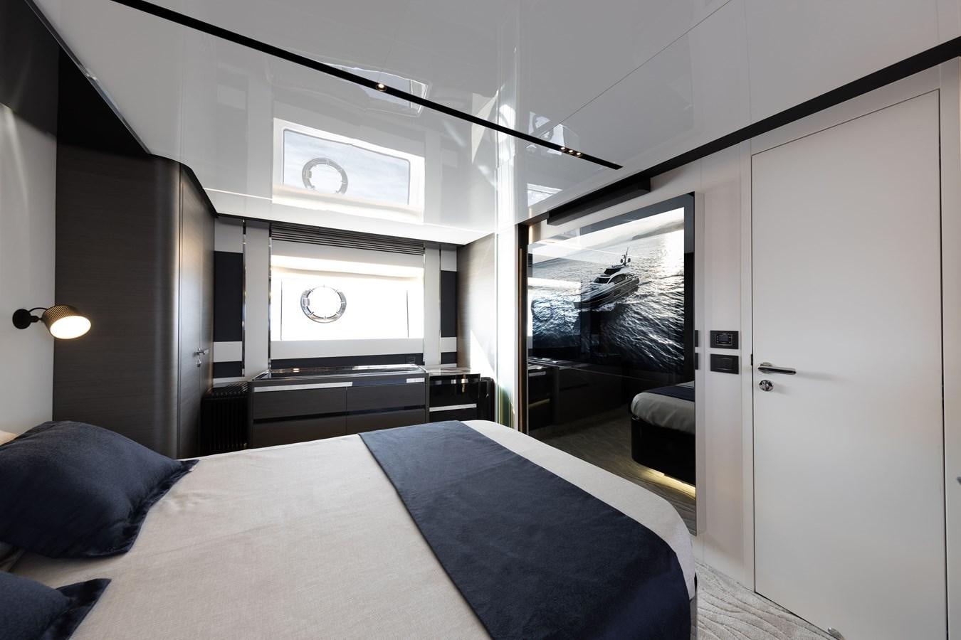 a bedroom with a bed and a tv aboard NEVER GIVE UP Yacht for Sale