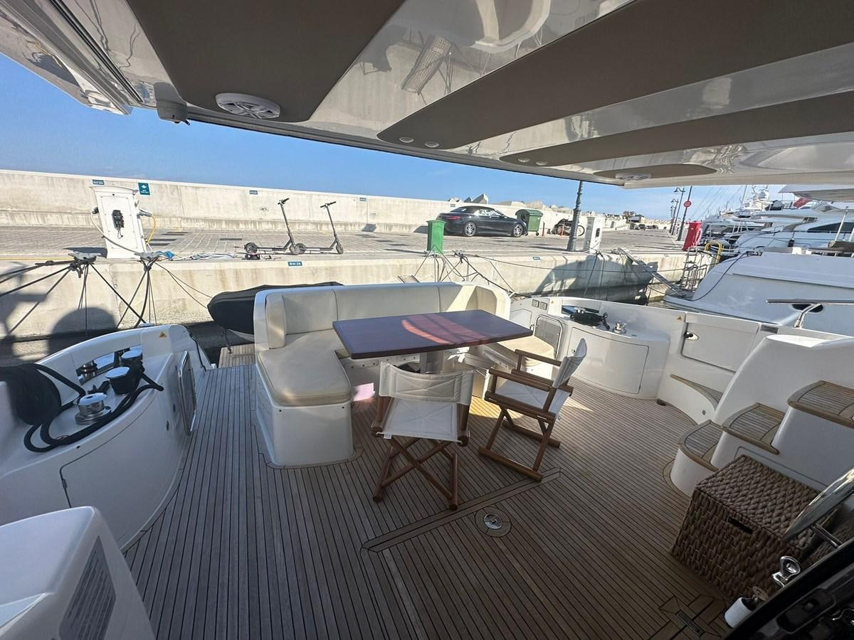 a boat deck with chairs and tables aboard AZIMUT 64 FLY 2014 Yacht for Sale
