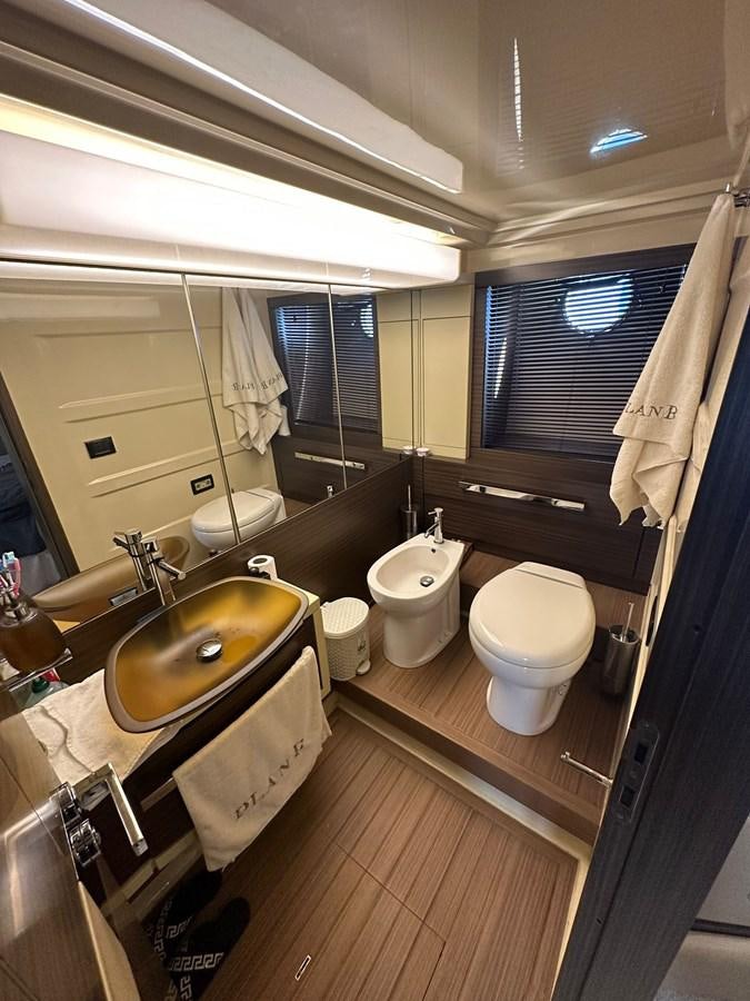 a bathroom with a sink toilet and a mirror aboard AZIMUT 64 FLY 2014 Yacht for Sale