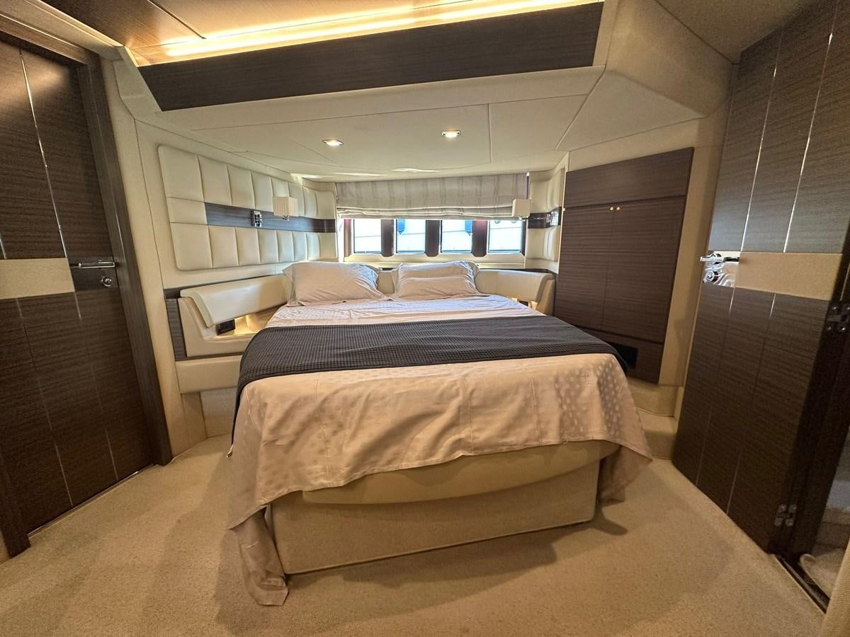 a room with a bed and a wood door aboard AZIMUT 64 FLY 2014 Yacht for Sale