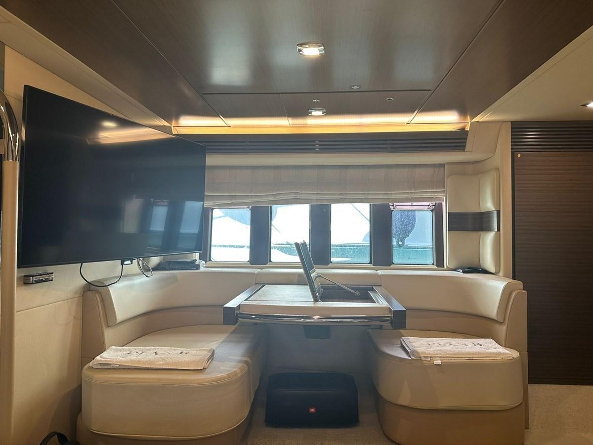 a room with a tv and a couch aboard AZIMUT 64 FLY 2014 Yacht for Sale