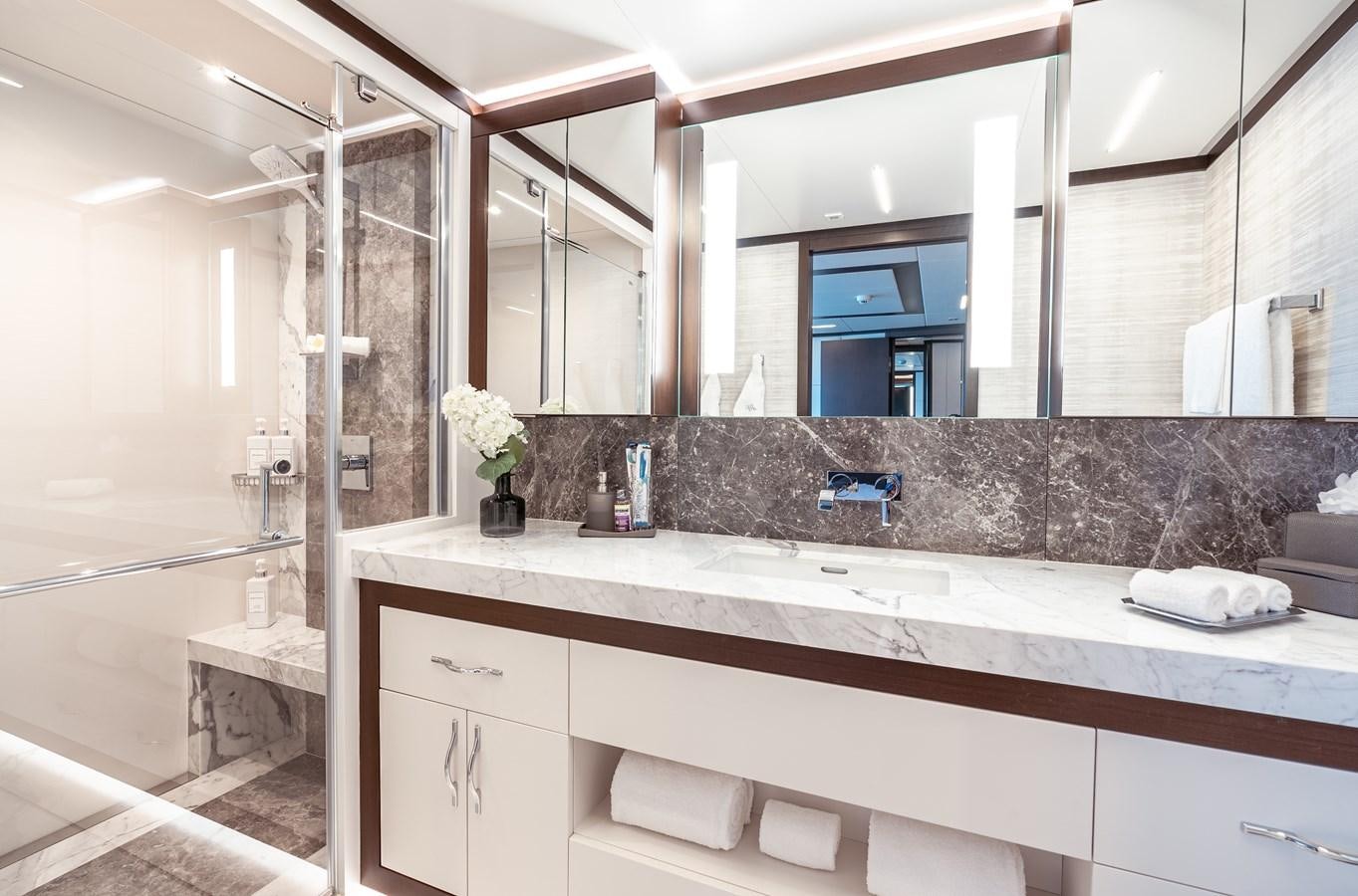 a bathroom with a large mirror aboard ROMEO FOXTROT Yacht for Sale