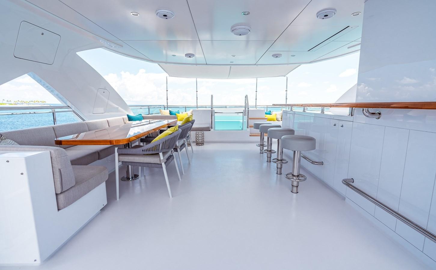 a room with tables and chairs aboard ROMEO FOXTROT Yacht for Sale
