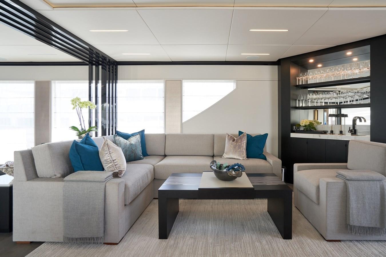 a living room with a couch and a coffee table aboard ROMEO FOXTROT Yacht for Sale