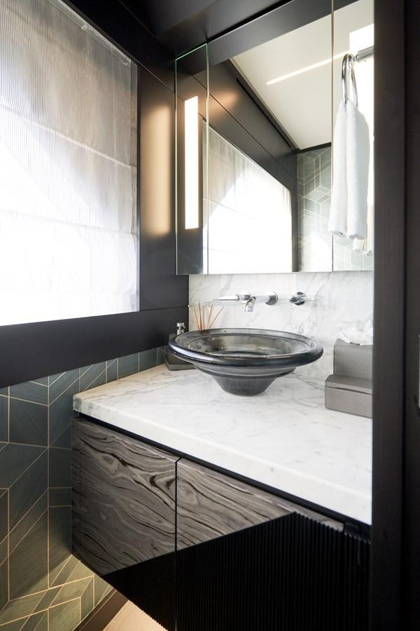 a bathroom with a sink and a mirror aboard ROMEO FOXTROT Yacht for Sale