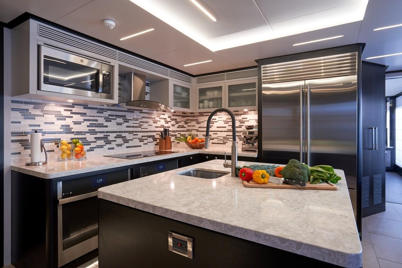 a kitchen with a large island aboard ROMEO FOXTROT Yacht for Sale