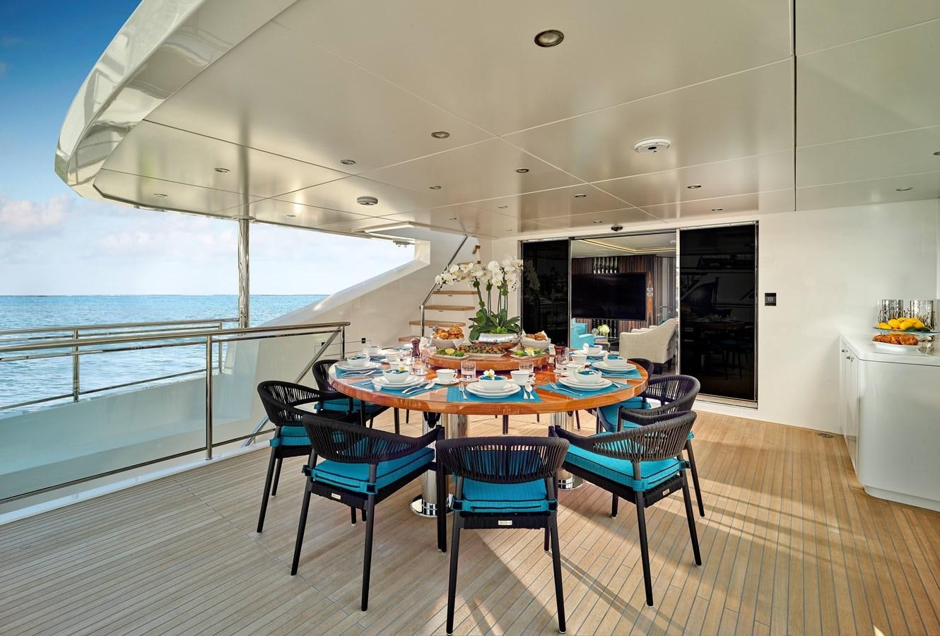 a table and chairs on a deck aboard ROMEO FOXTROT Yacht for Sale
