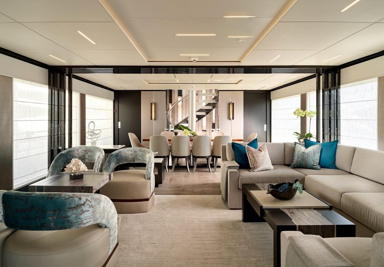 a living room with a couch and chairs aboard ROMEO FOXTROT Yacht for Sale