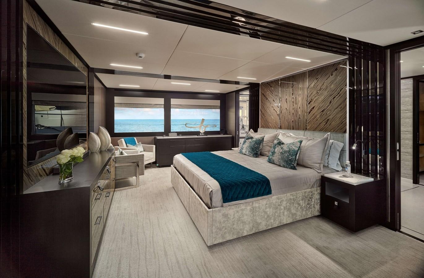 a room with a bed and a large window aboard ROMEO FOXTROT Yacht for Sale