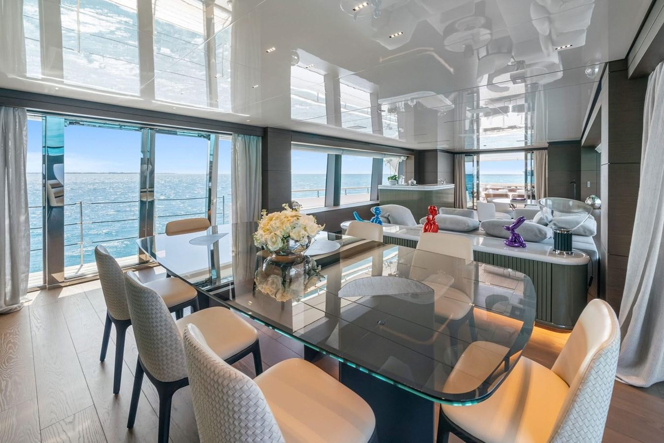 a large room with a table and chairs aboard ASANTE Yacht for Sale
