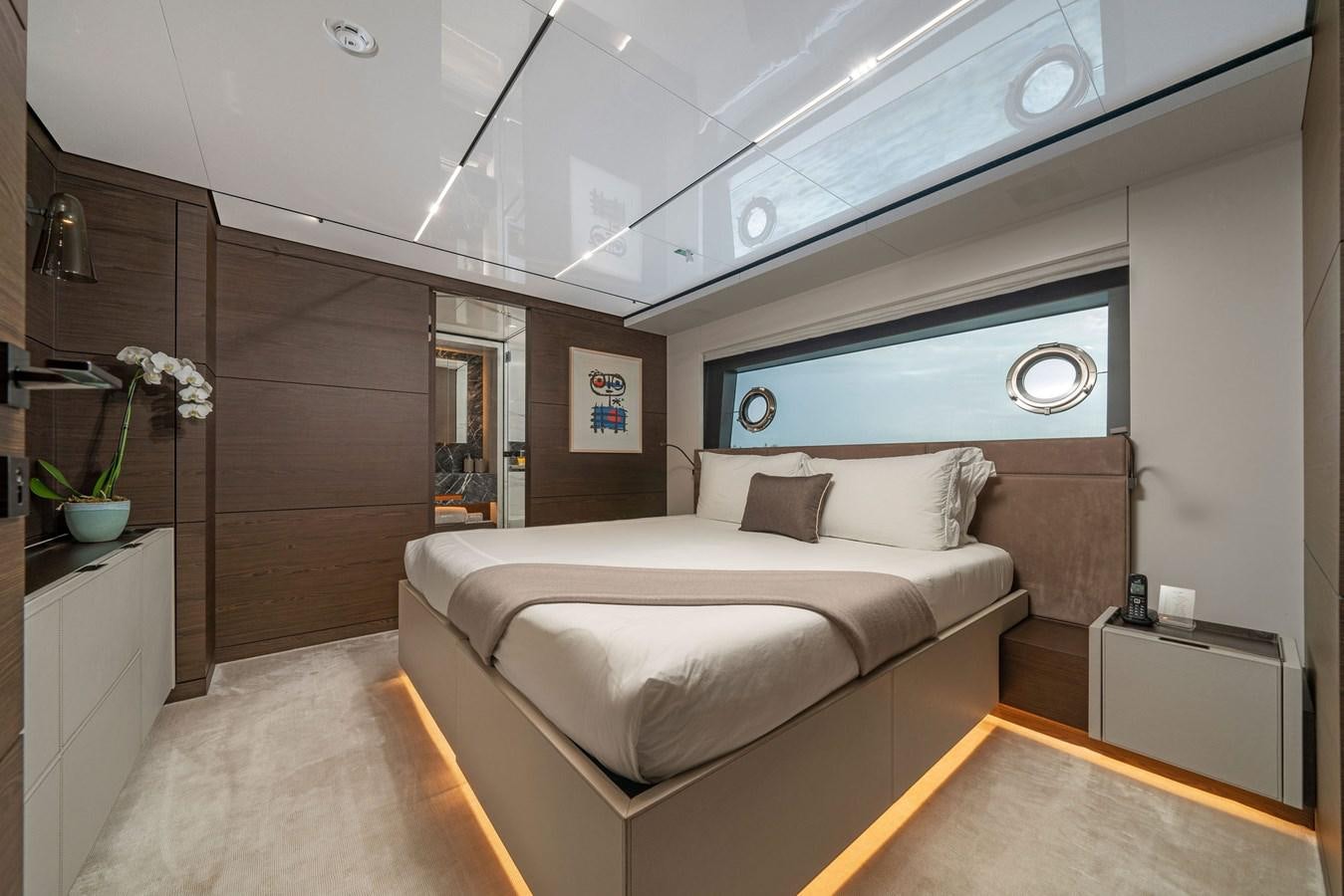 a room with a bed and a desk aboard ASANTE Yacht for Sale