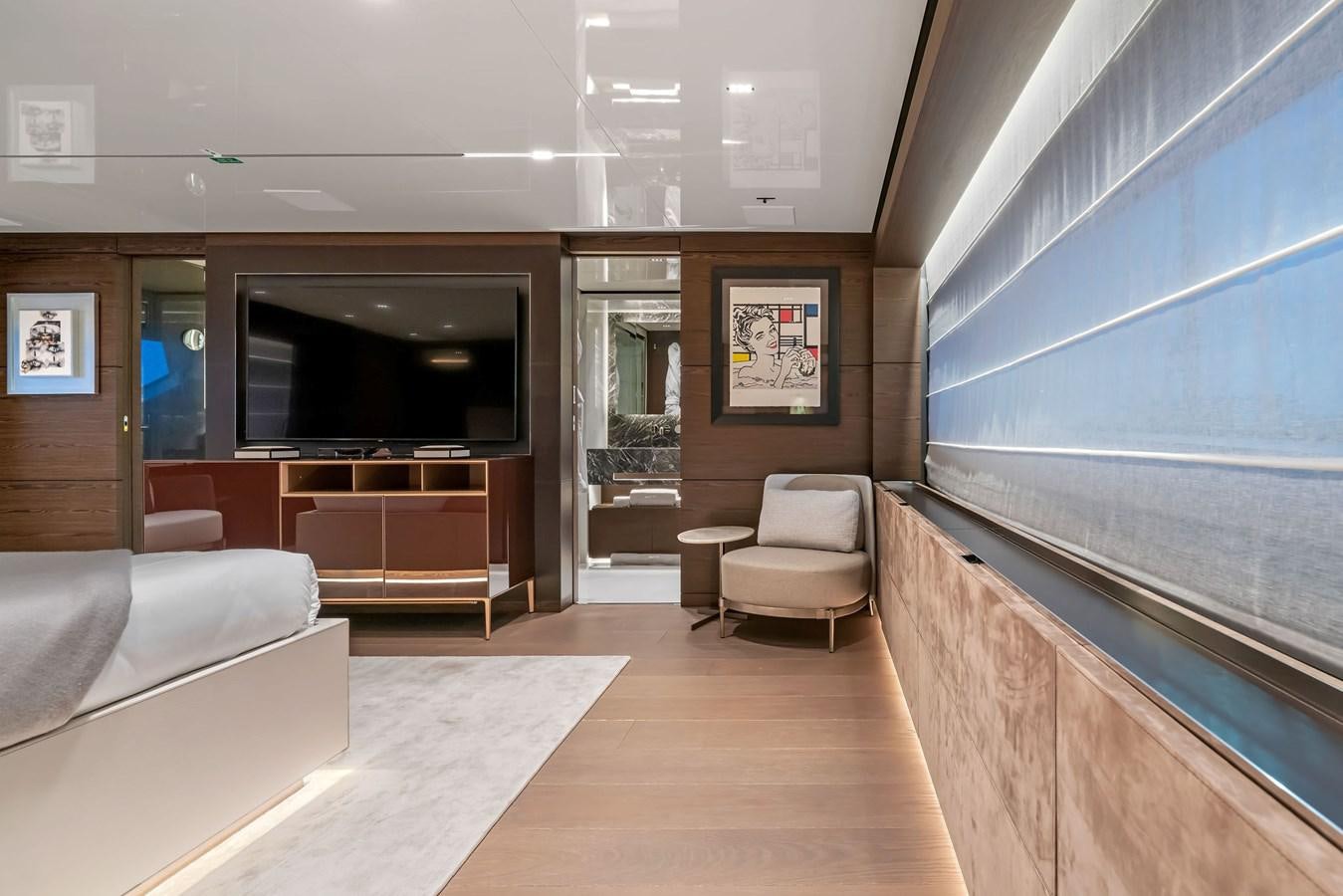 a room with a tv and couches aboard ASANTE Yacht for Sale
