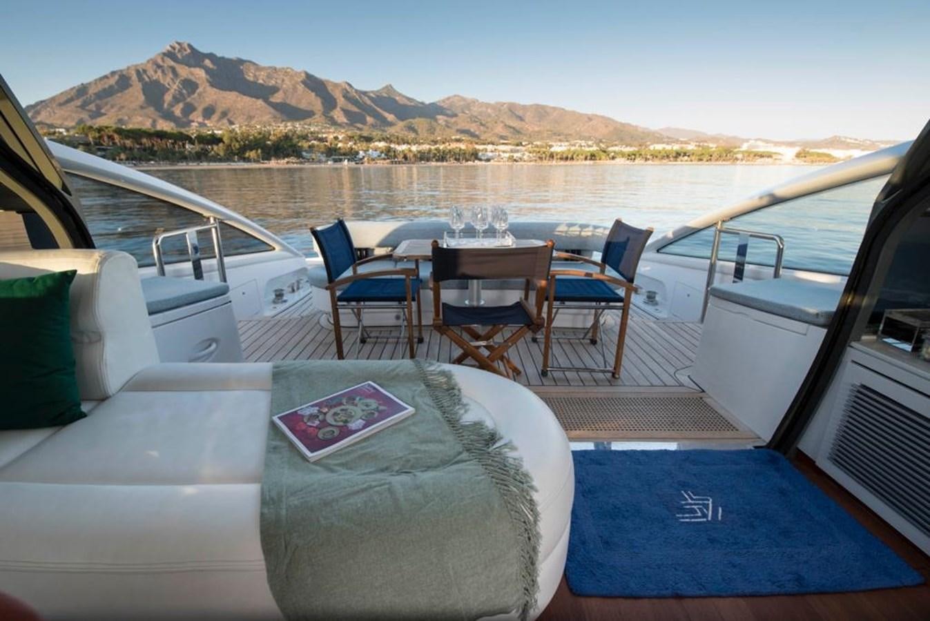 a boat with a table and chairs on it aboard 4F Yacht for Sale