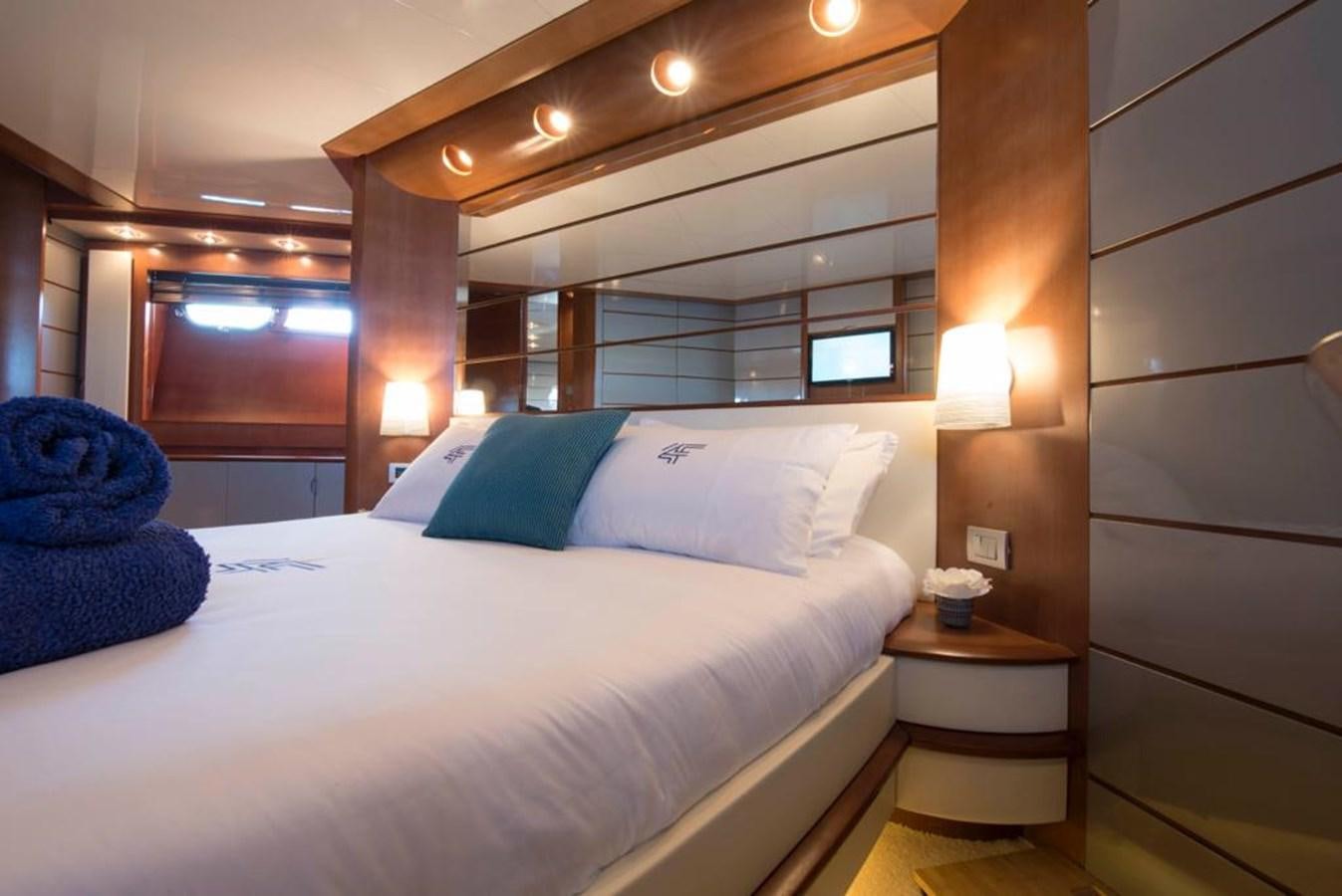 a bed with a white bed spread aboard 4F Yacht for Sale