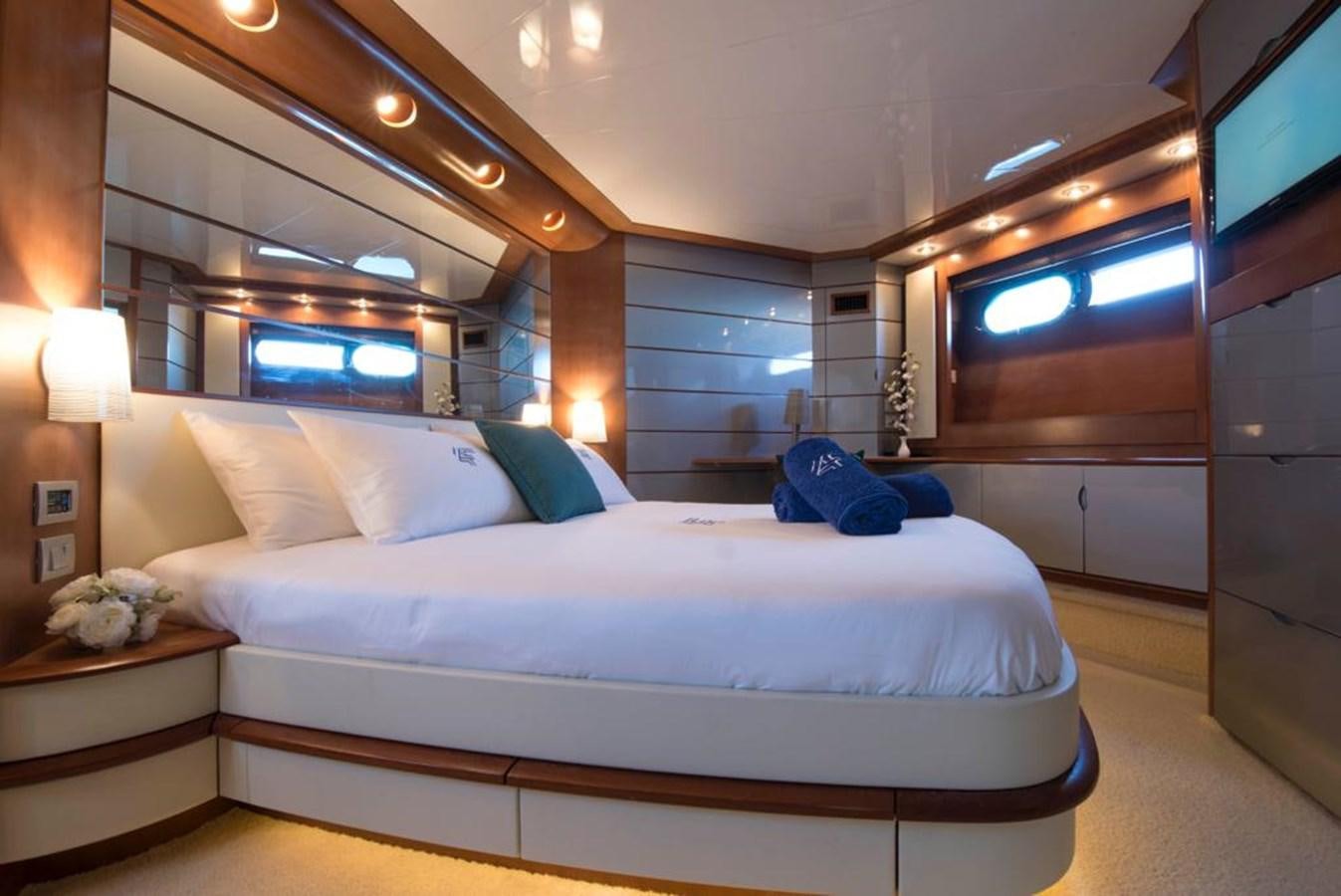 a bed with a white bed spread aboard 4F Yacht for Sale