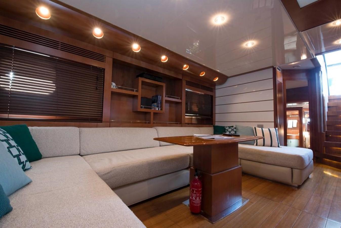 a living room with a fireplace aboard 4F Yacht for Sale