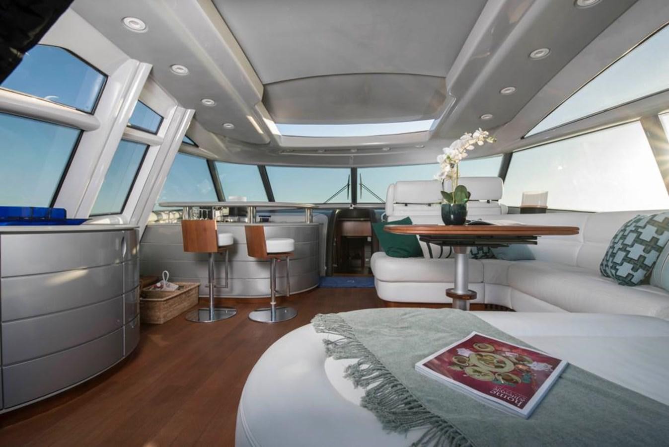 a room with a table and chairs aboard 4F Yacht for Sale