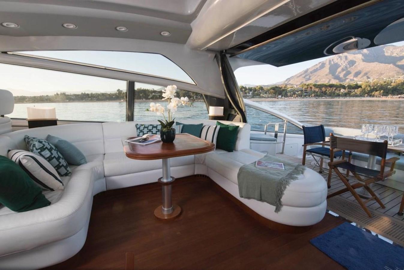 a living room with a table and chairs aboard 4F Yacht for Sale