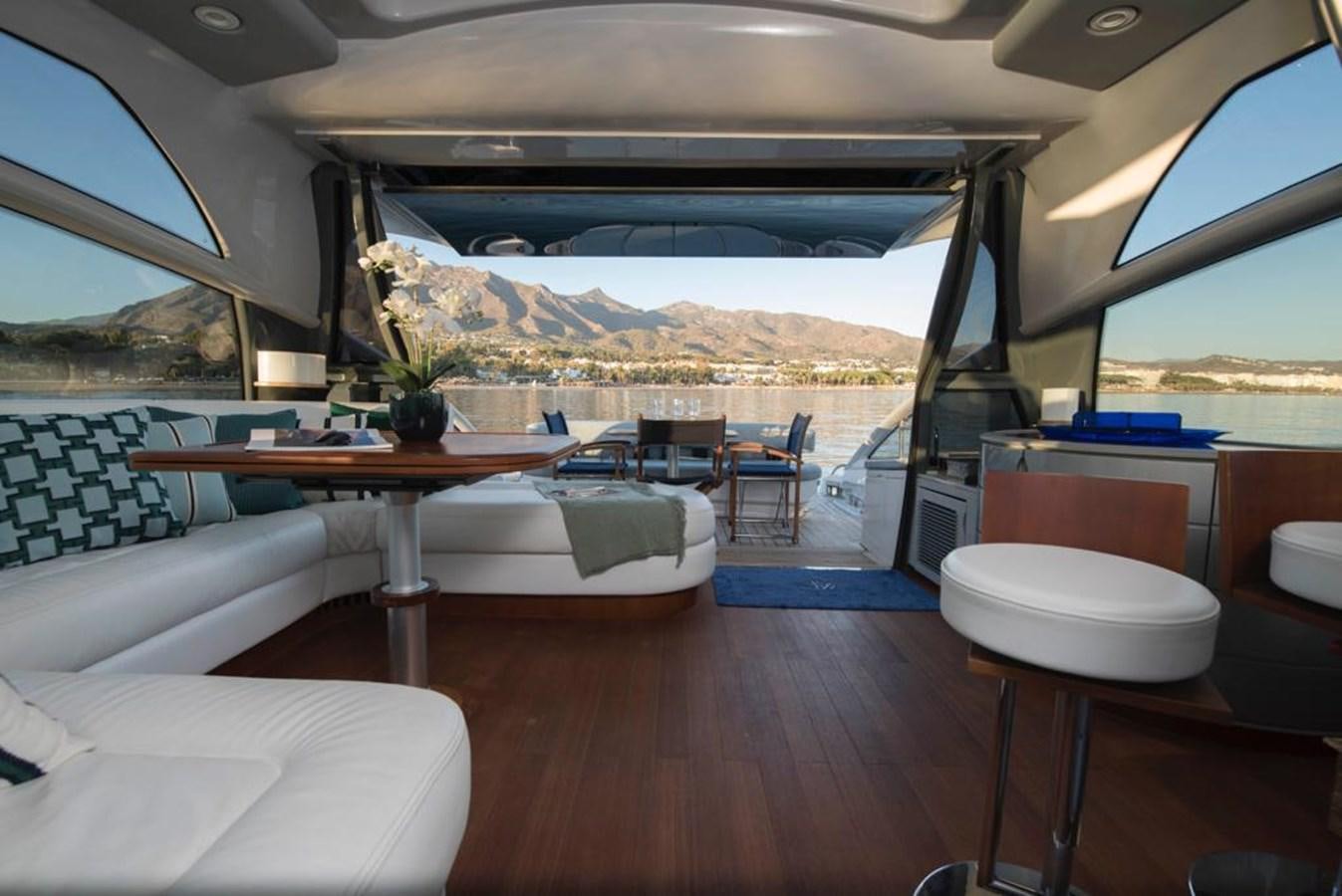 a room with a table chairs and a large umbrella aboard 4F Yacht for Sale