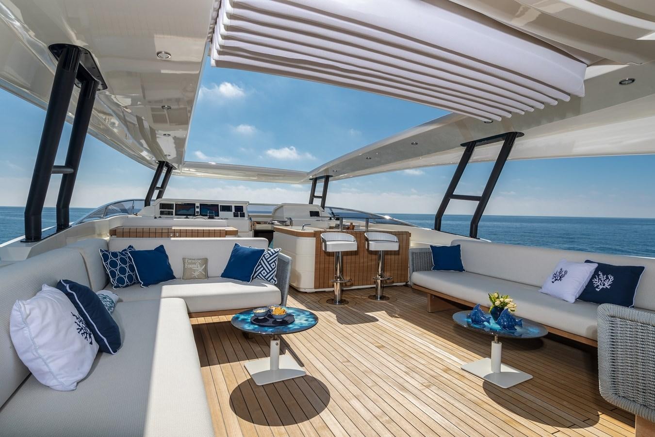 a room with a large bed and a table with chairs aboard MARENGO UNO Yacht for Sale
