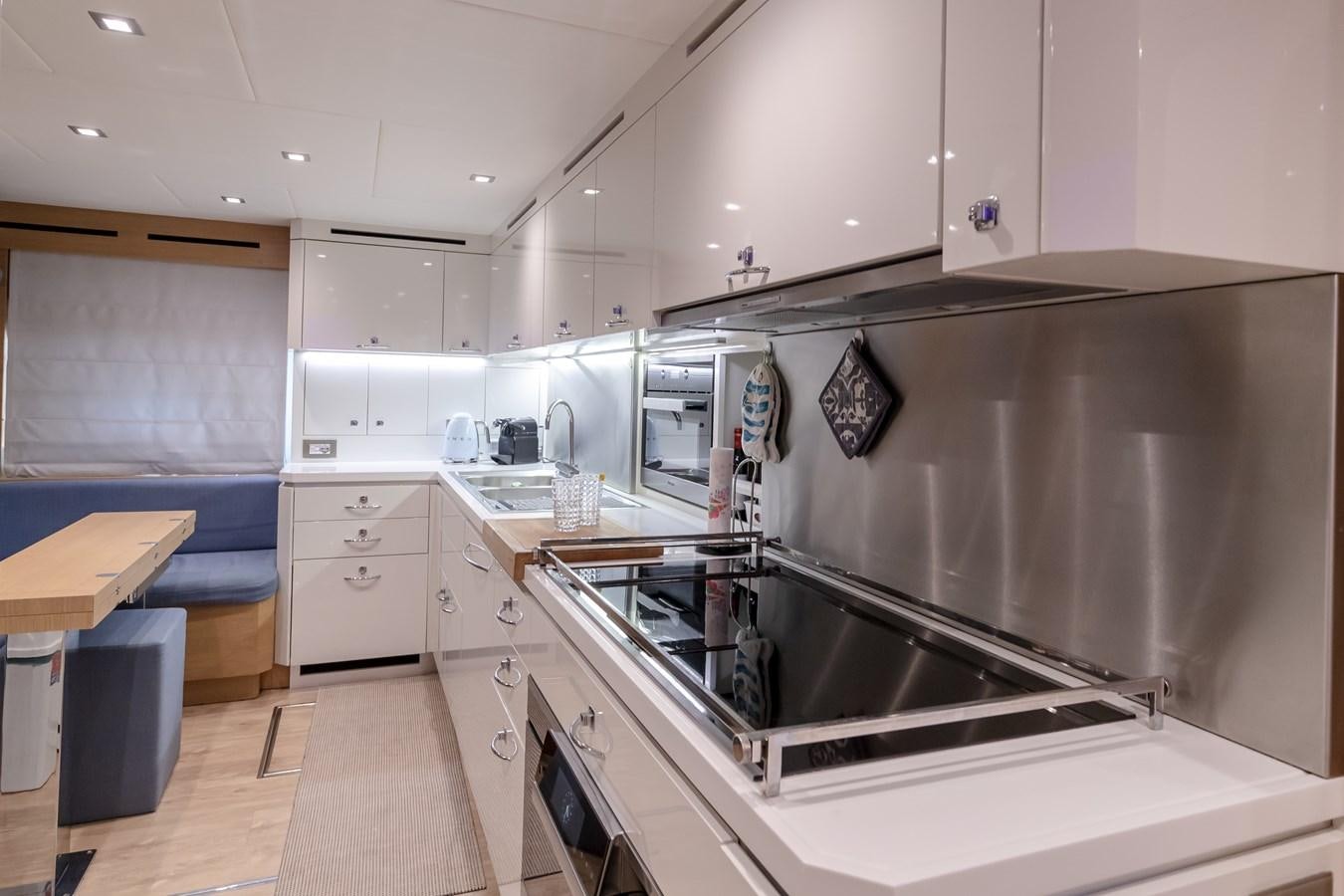 a kitchen with white cabinets aboard MARENGO UNO Yacht for Sale