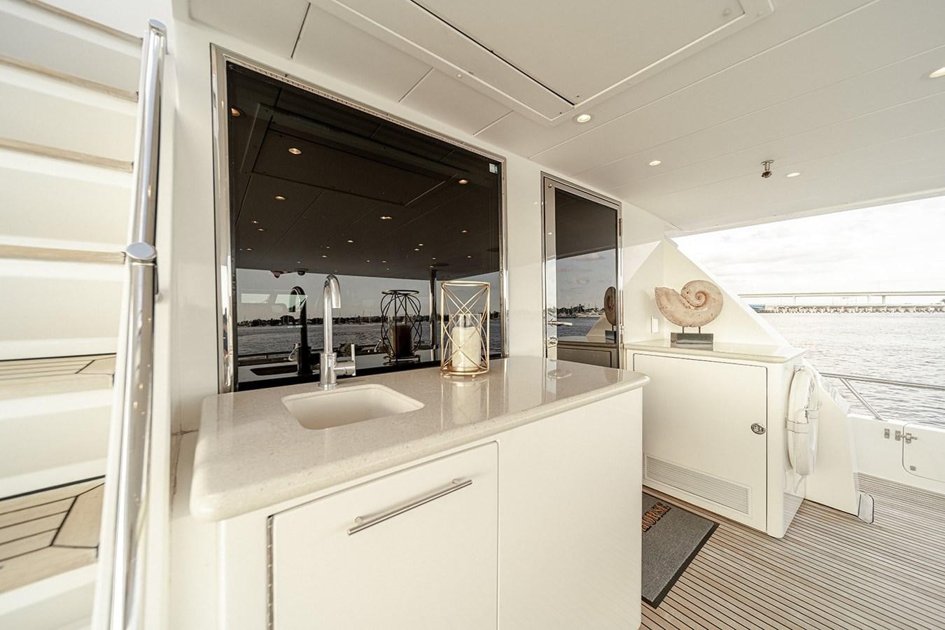 a bathroom with a sink and a large window aboard DARK HORSE Yacht for Sale