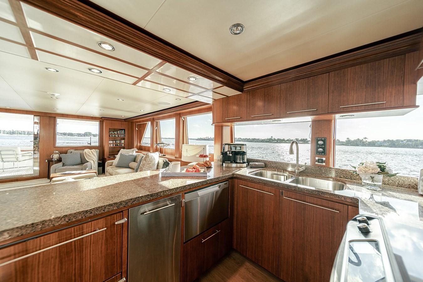 a kitchen with wooden cabinets aboard DARK HORSE Yacht for Sale