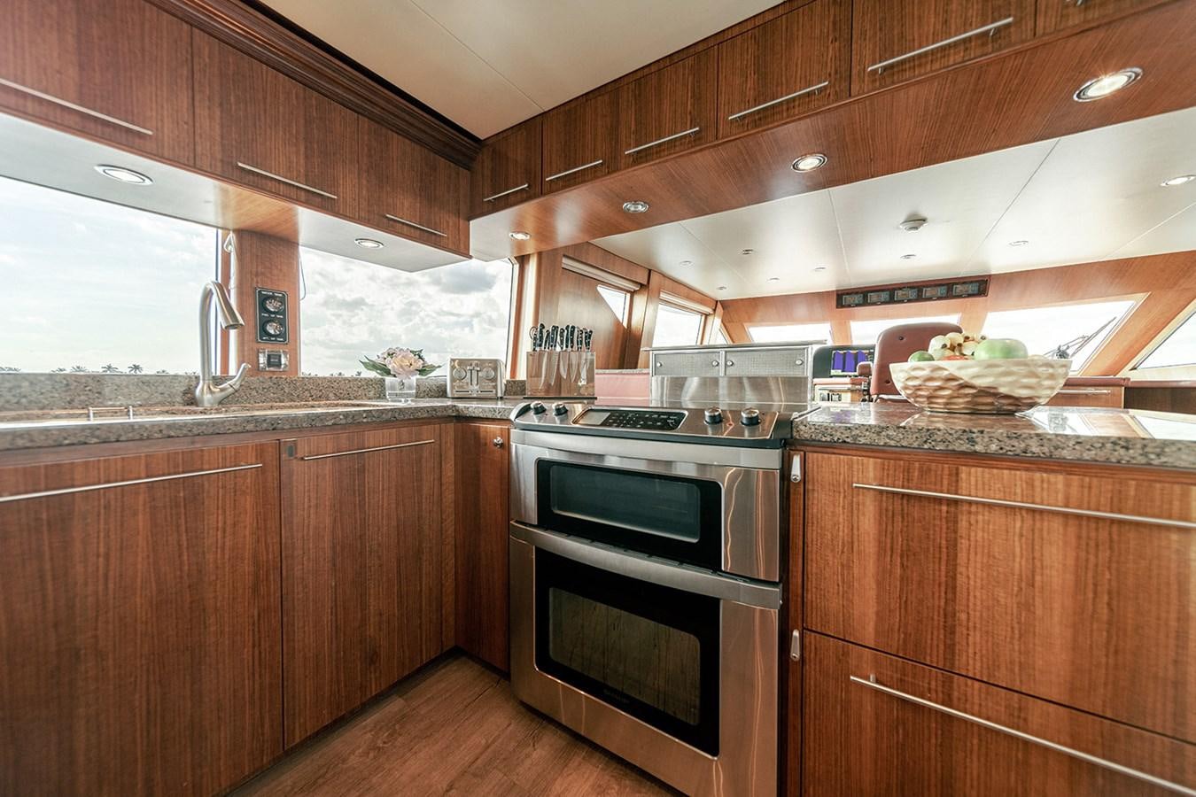 a kitchen with wooden cabinets aboard DARK HORSE Yacht for Sale