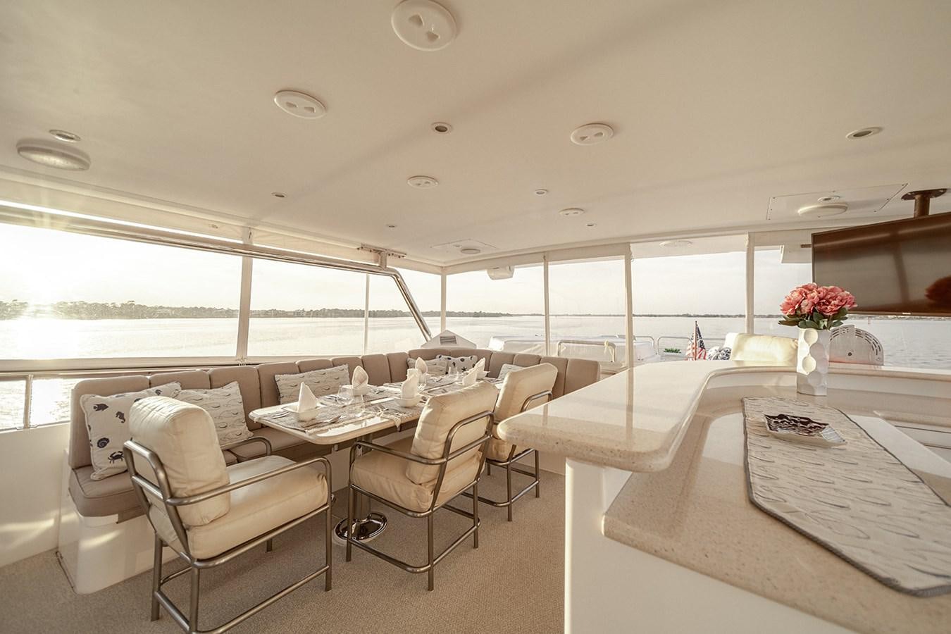 a room with tables and chairs aboard DARK HORSE Yacht for Sale