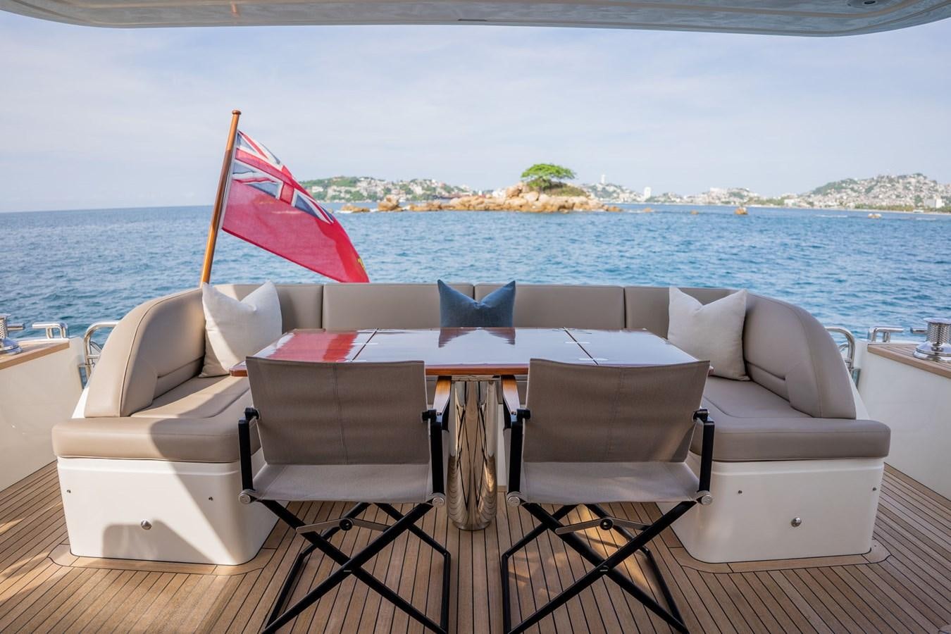 a table and chairs on a beach aboard PICHOS III Yacht for Sale