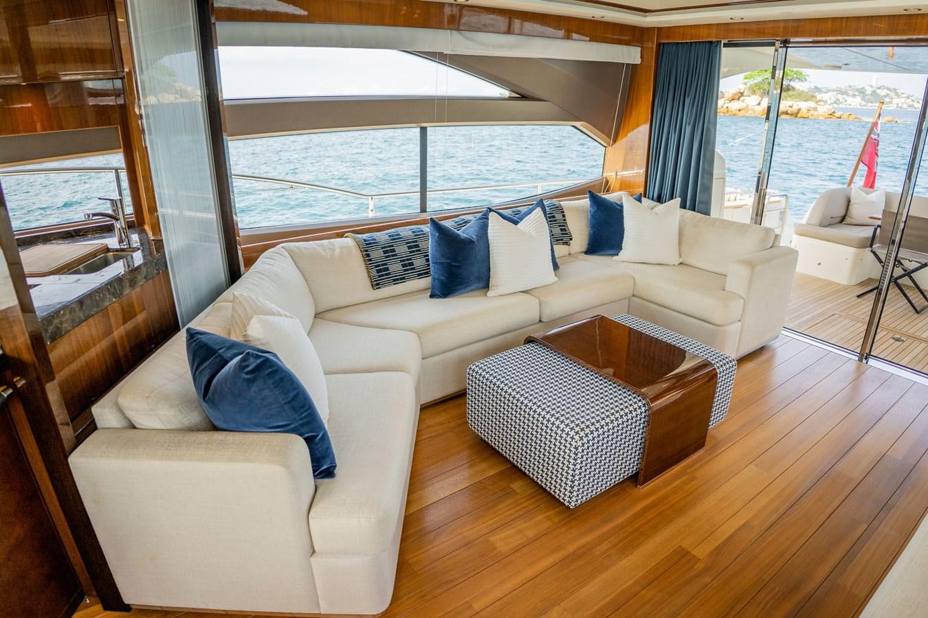 a living room with a large window aboard PICHOS III Yacht for Sale