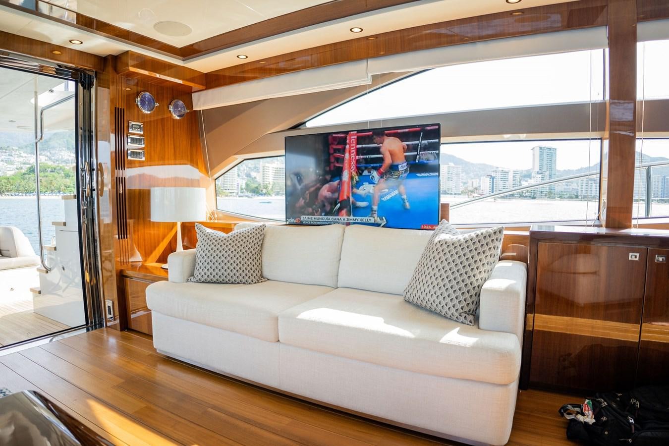 a living room with a large screen aboard PICHOS III Yacht for Sale