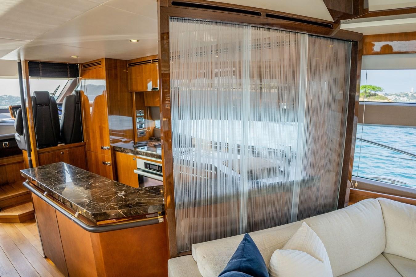 a kitchen with a large glass window aboard PICHOS III Yacht for Sale