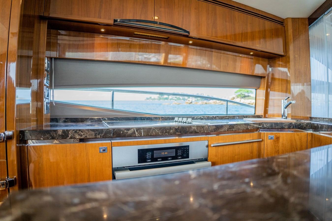a kitchen with a large glass window aboard PICHOS III Yacht for Sale