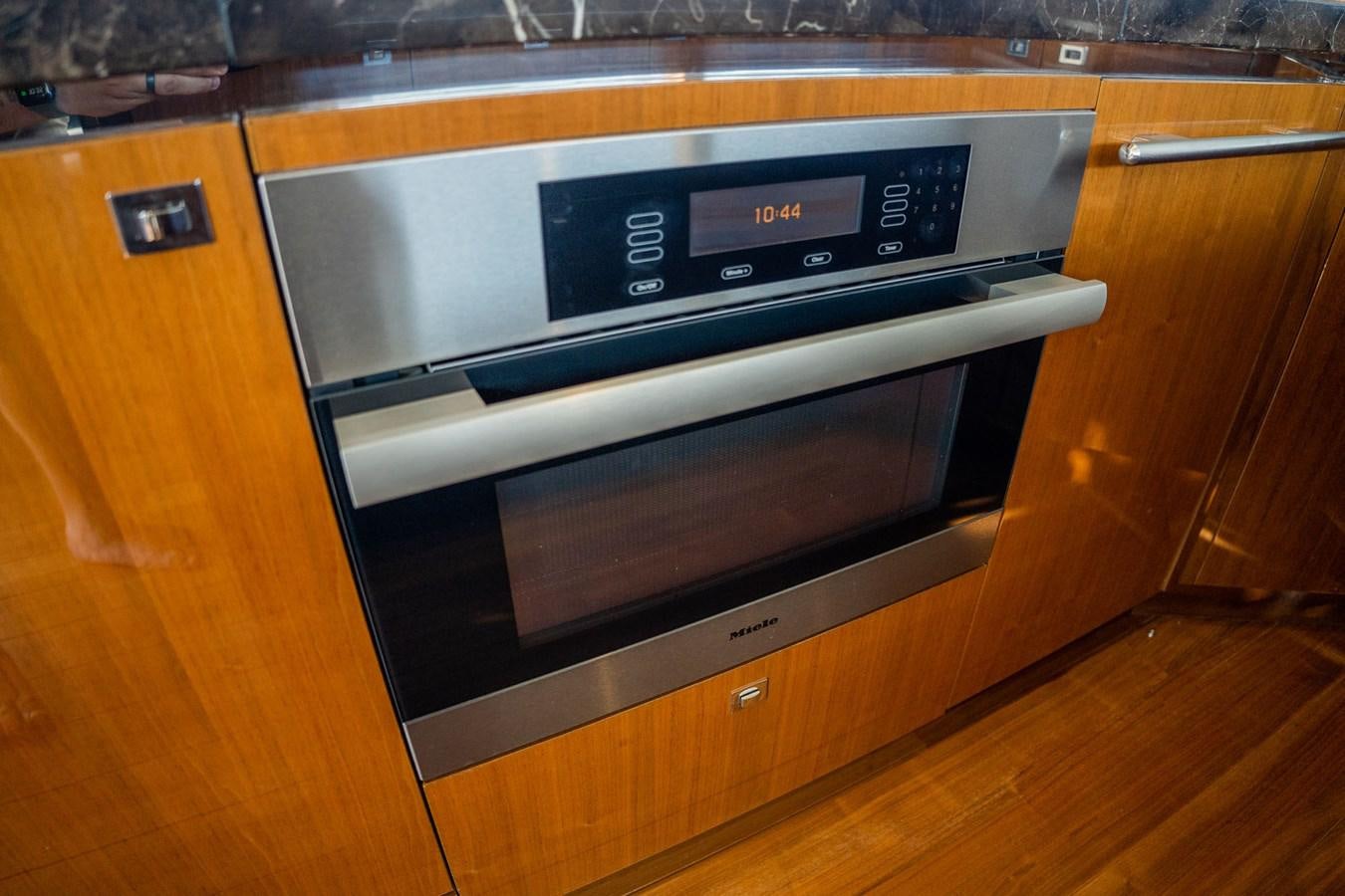 a kitchen with a stainless steel oven aboard PICHOS III Yacht for Sale