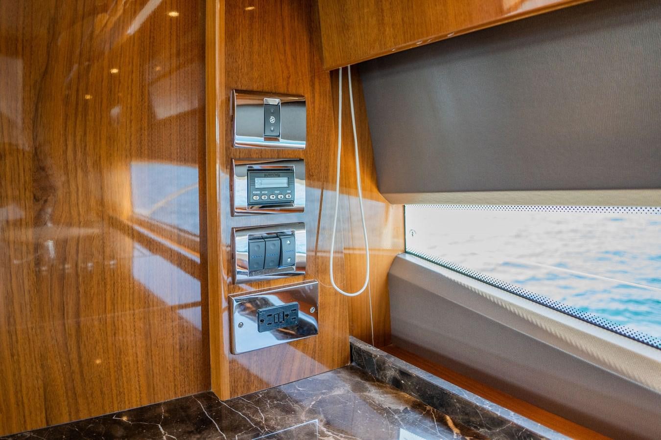 a wooden wall with a computer and a computer on it aboard PICHOS III Yacht for Sale