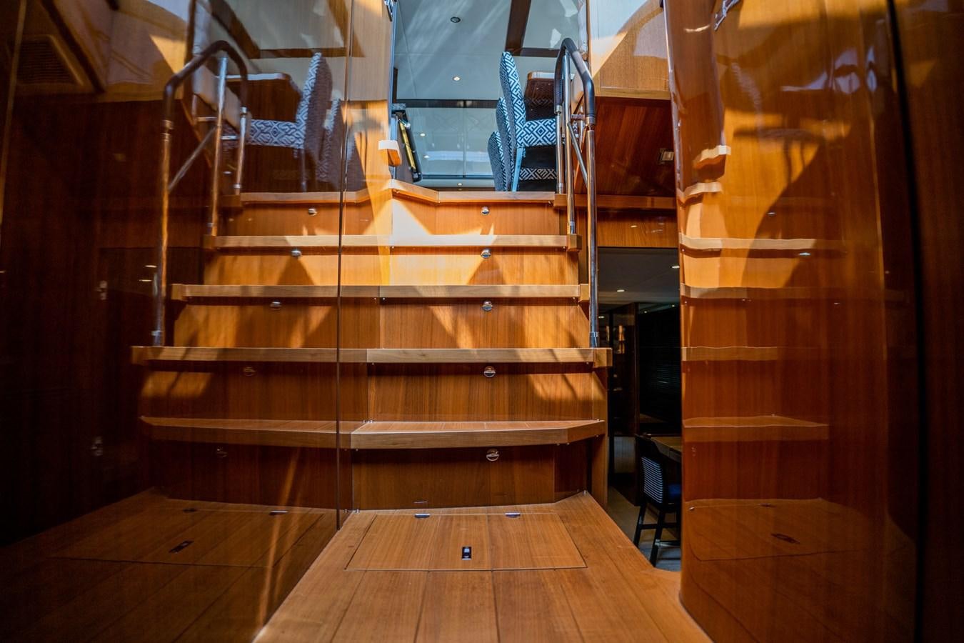 a wooden staircase with a glass door aboard PICHOS III Yacht for Sale